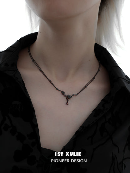 Y2K goth rose necklace from 1STXULIE featuring a dark design on a model's neck