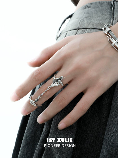 Trendy Y2K punk silver ring on hand with chain details for a bold fashion statement