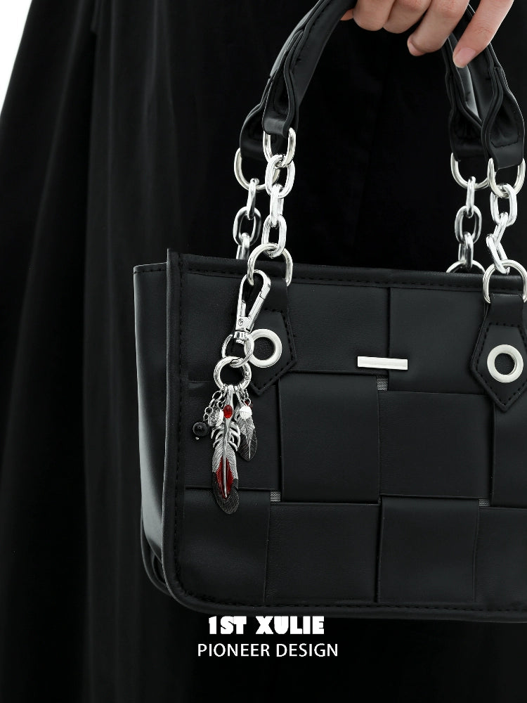 Stylish black handbag with silver chain and Y2K red witch feather necklace charm attached