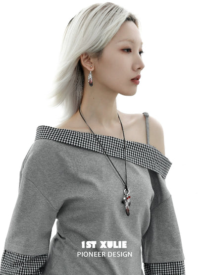 Model wearing Y2K red witch feather necklace paired with off-shoulder gray top for a stylish look