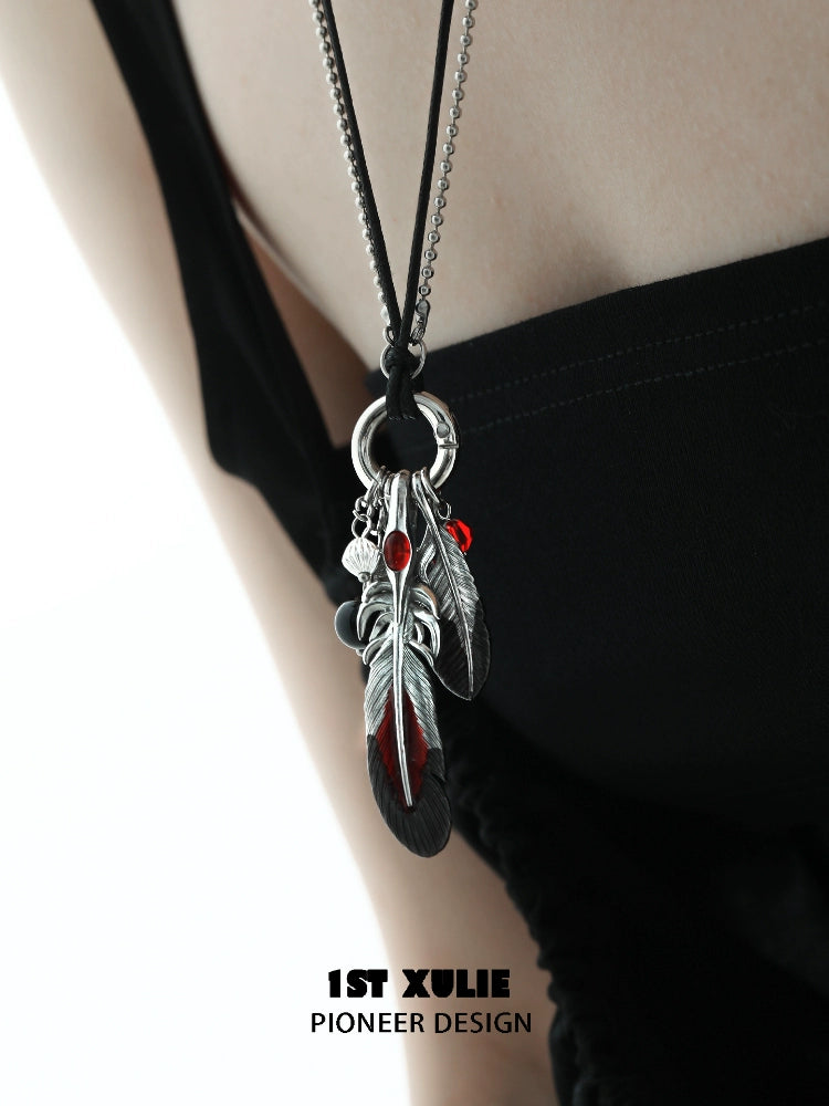 Y2K red witch feather necklace with silver charms on a black cord for a trendy bohemian look