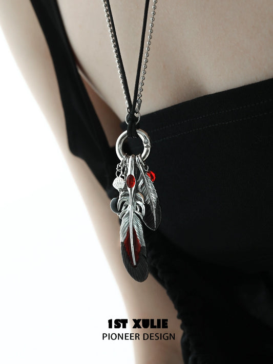 Y2K red witch feather necklace with silver charms on a black cord for a trendy bohemian look